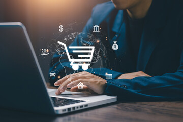 Business professional using laptop with digital shopping cart and global icons, representing e-commerce, online payment, fintech, and global marketplace growth in modern digital business environment. © saranyoo