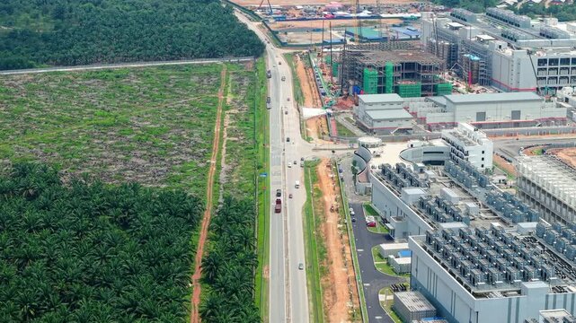 Aerial Push-In Showing Data Center Campus Directly Beside Cleared Palm Oil Plantation, Johor Malaysia