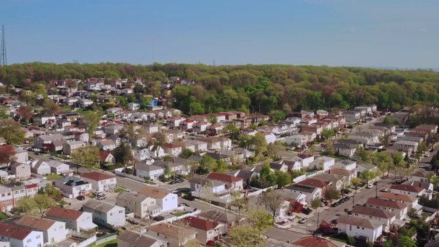 4K aerial shot of a residential neighborhood in Staten Island, New York. This sunny spring day captures suburban blocks and everyday street traffic.