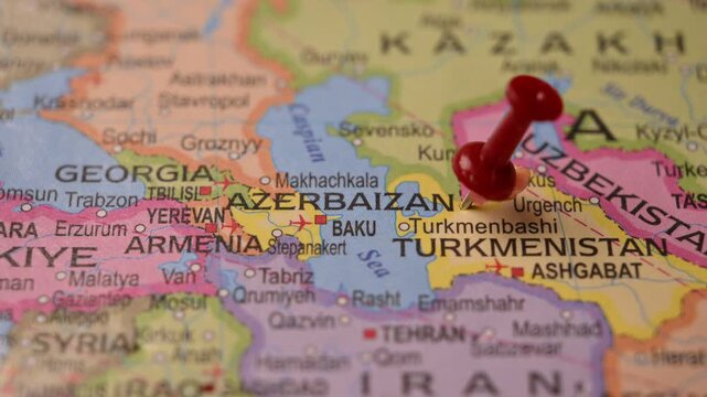 Close-Up World Map Shot Featuring Red Pin Highlighting Azerbaijan Pointed by Hand 4K 60fps