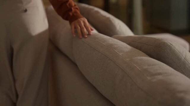 Close Up of a Hand Feeling the Couch Fabric Texture luxury life style.