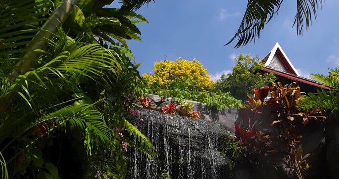 Artificial waterfall cascading in a tropical thai garden in side Historic Golden mount.