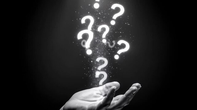 Glowing hand releasing sparkling question marks into dark mysterious space with magical light effects