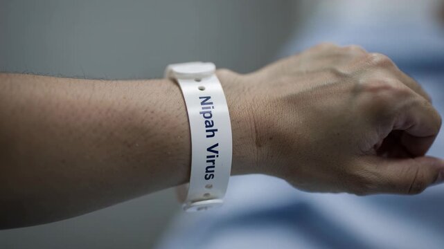 Close up of hospital wristband labeled Nipah virus on patient arm medical identification healthcare