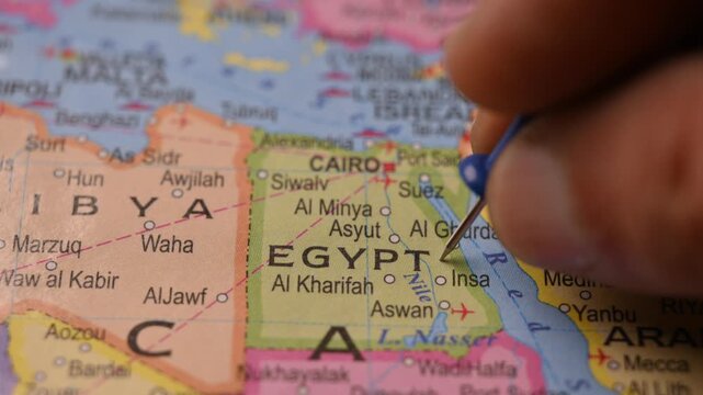 Close-Up World Map Shot Featuring Blue Pin Highlighting Cairo Egypt Pointed by Hand 4K 60fps