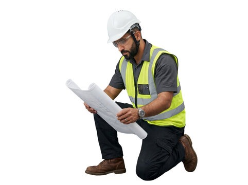 A Hispanic construction engineer crouches down and looks at blueprints