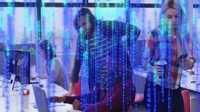 IT team leaning over laptop, checking screen beneath blue code overlay appearing and fixing issue
