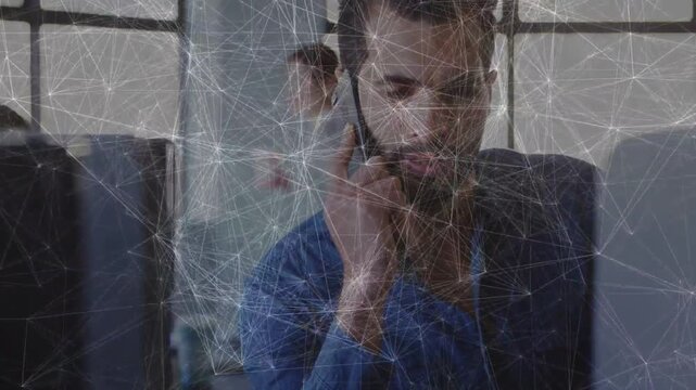 Man raising phone, conducting business call for update, web overlay tracing link to monitor