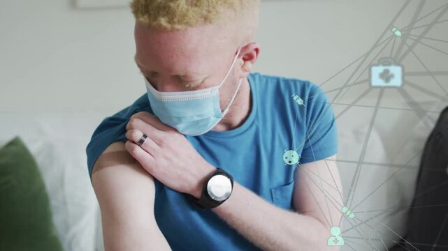 Man pulling sleeve up and checking left arm bandage on couch, health graphics intensifying right