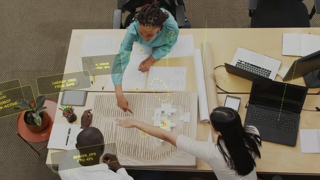 Lead designer pointing, leading colleague moving blocks and aligning HUD, finalizing design layout