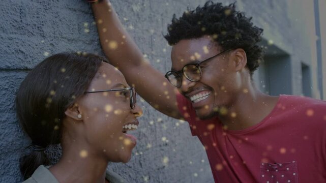 Woman laughing man leaning by gray wall laughter getting closer golden bokeh drifting enhancing ads