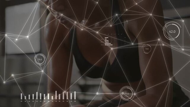 Woman performing plank in gym, gripping weight and driving AR HUD updates for biometric monitoring