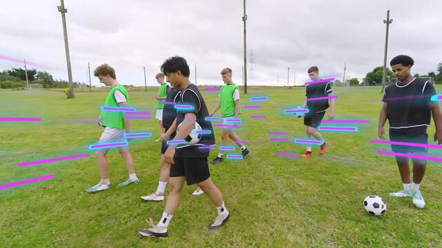 On coach cue boys walking across pitch for drill with soccer balls neon-blue magenta streaks moving