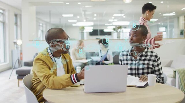 Left person gesturing at laptop, activating BTC overlay across faces as right person noting finance