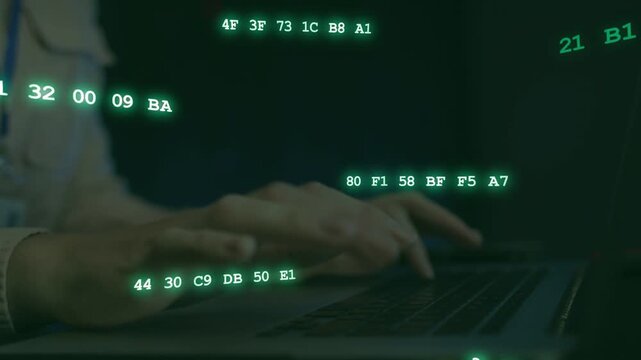 Woman at desk starting typing, causing green hex strings increasing over keys for tech analysis