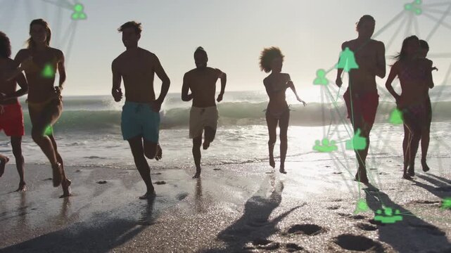 Group sprinting to camera from surf on beach for tech ad while green network tracking runners