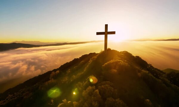 a wooden Christian cross placed prominently on a mountaintop.