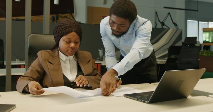 Team members engaged in detailed report review and mentorship