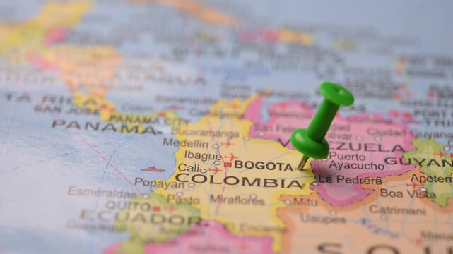 Man Pointing Green Pin at Bogota on World Map 4K 60fps