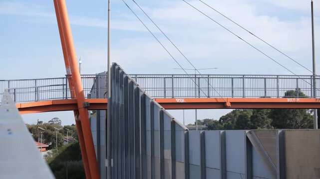 A cyclist crossing&nbsp; pedestrian and cycling bridge in Laverton, Melbourne Australia. A person riding a bike, passing across the elevated shared path.&nbsp;Infrastructure&nbsp;connecting suburban communities