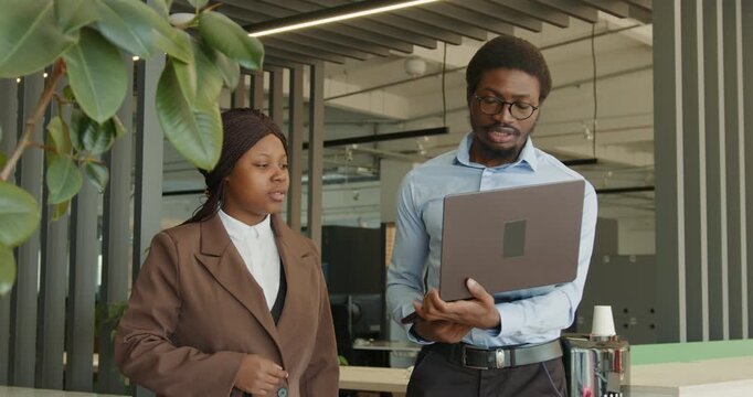 Confident professionals evaluating data and visuals in work environment