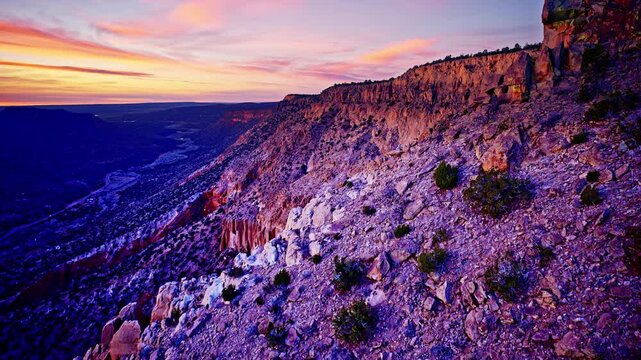 Aerial drone shot soaring over rugged red rock canyon terrain in New Mexico