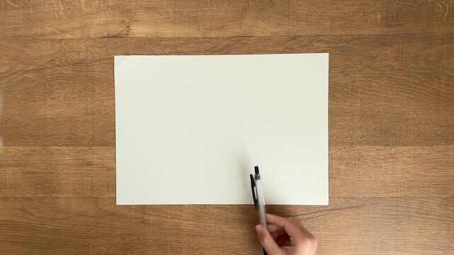 Child's Hand Placing a Black Ballpoint Pen on A4 Paper, 4K Slow Motion
