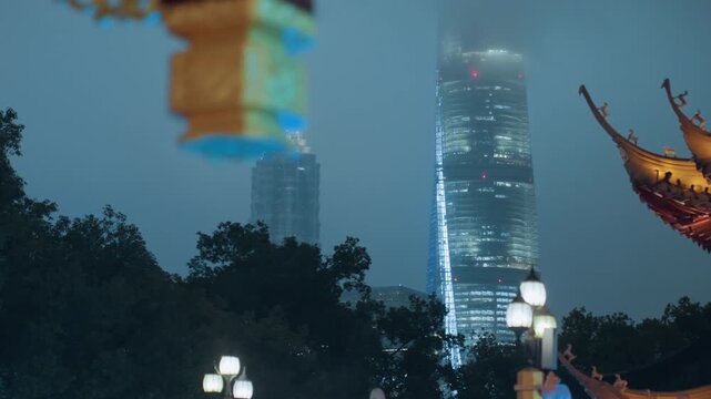 Misty skyline with lantern and pagoda, modern tower rising through fog, park lamps glowing amid treetop silhouettes, ornate roof corner framing illuminated windows, tranquil nocturnal contrast