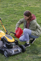 Fototapeta premium Refueling Lawn Mower Outdoors – Garden Maintenance and Yard Care Concept – Countryside Living and Outdoor Chores Lifestyle