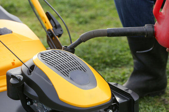 Refueling Lawn Mower Outdoors &ndash; Garden Maintenance and Yard Care Concept &ndash; Countryside Living and Outdoor Chores Lifestyle