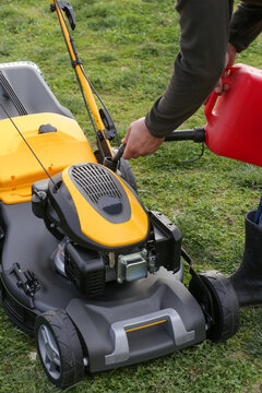 Refueling Lawn Mower Outdoors &ndash; Garden Maintenance and Yard Care Concept &ndash; Countryside Living and Outdoor Chores Lifestyle
