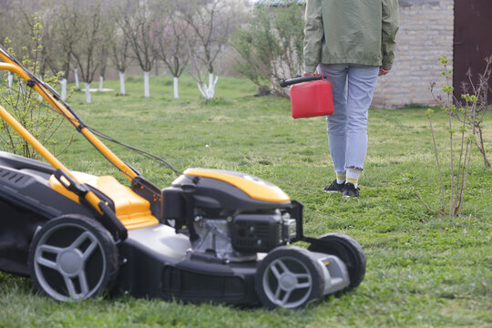 Refueling Lawn Mower Outdoors &ndash; Garden Maintenance and Yard Care Concept &ndash; Countryside Living and Outdoor Chores Lifestyle