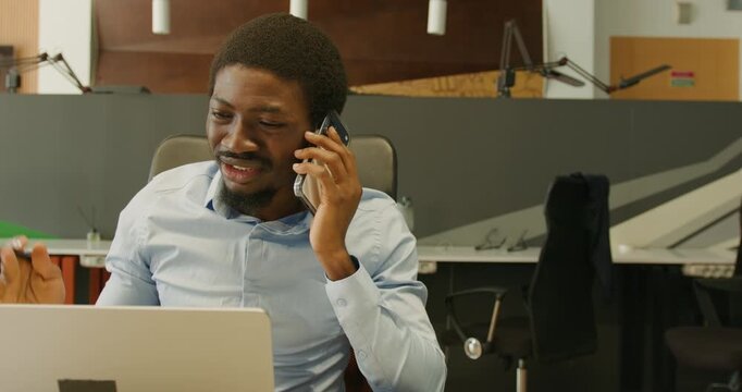 Black consultant animated on phone celebrating progress
