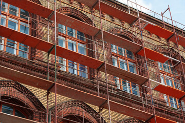 Renovation of a historic brick building with metal scaffolding in Budapest Hungary during...