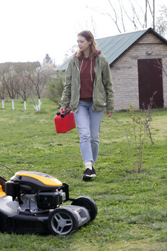 Refueling Lawn Mower Outdoors &ndash; Garden Maintenance and Yard Care Concept &ndash; Countryside Living and Outdoor Chores Lifestyle
