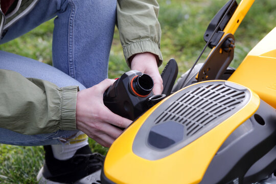 Pouring Oil Into Lawn Mower and Checking Oil Level &ndash; Small Engine Maintenance Close Up - Countryside Living and Outdoor Chores Lifestyle