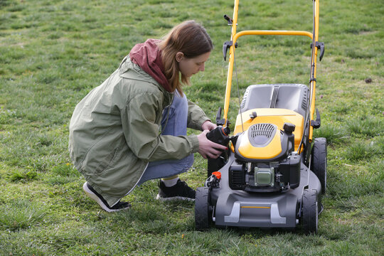 Pouring Oil Into Lawn Mower and Checking Oil Level &ndash; Small Engine Maintenance Close Up - Countryside Living and Outdoor Chores Lifestyle