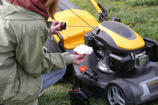 Pouring Oil Into Lawn Mower and Checking Oil Level &ndash; Small Engine Maintenance Close Up - Countryside Living and Outdoor Chores Lifestyle