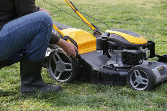 Adjusting Lawn Mower Cutting Height &ndash; Close Up of Grass Cutting Preparation and Maintenance