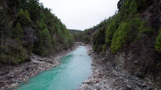 Drone view Parlung Zangbo river running along G318 or China National Highway 318 between Bomi and Baxoi County, Tibet, China, beautiful turquoise water in valley, 4k real time footage travel concept.