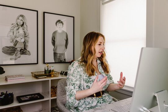 Woman working at home office desk with computer