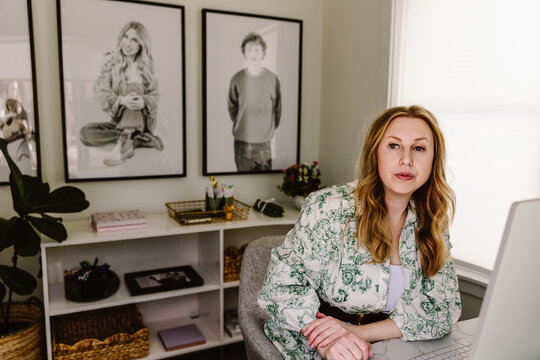 Focused woman working at home desk