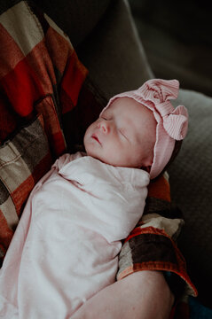 Close-up of baby girl being held in fathers arm