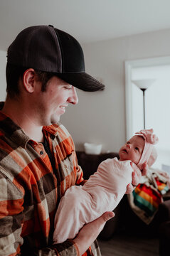 Young Father holding newborn baby girl