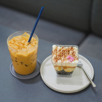 Savoring iced coffee and dessert cozy  relaxed atmosphere inviting vibes
