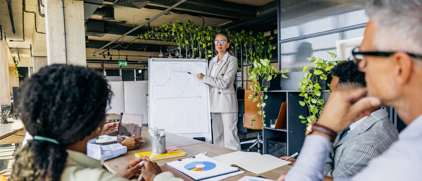Entrepreneurs sharing insights amidst lively office environment