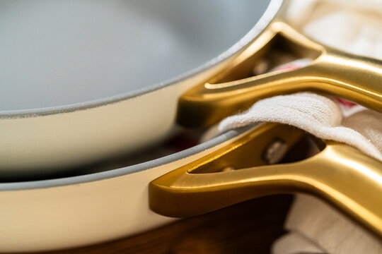 Stacked White Cookware with Golden Handles