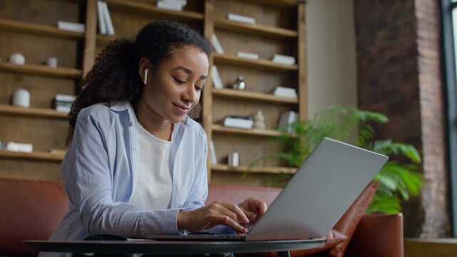 Student Working On Laptop In Lounge