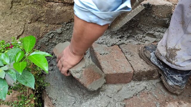 Adjusting a brick on a new stair step