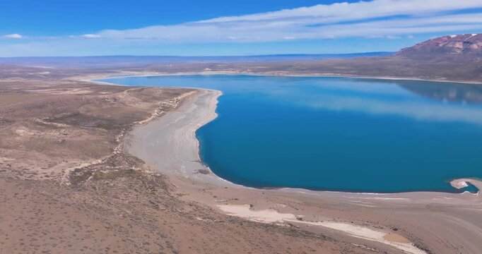4K video; aerial view with slow panning movement over landscape with the blue lake Lago Ghio and mountains in the foothills of the Andes, Patagonia Argentina